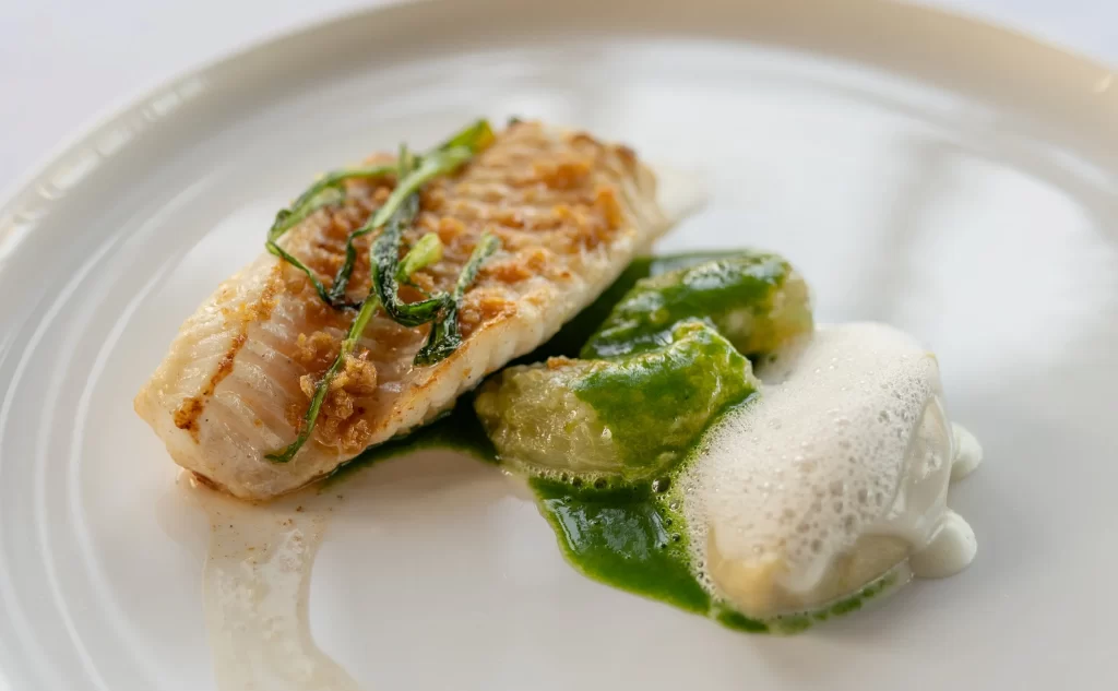 Alléno au Pavillon Ledoyen Alléno au Pavillon Ledoyen - Sole cooked meuinere style with crispy chicken skin, puntarella, and Parmigiano cheese.
